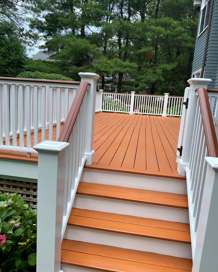 Composite deck stairs leading down to a backyard deck.