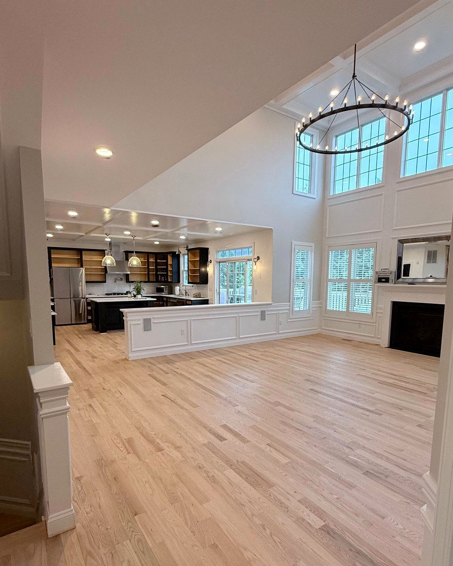 Wide-plank hardwood installed through an open-concept living and dining area.