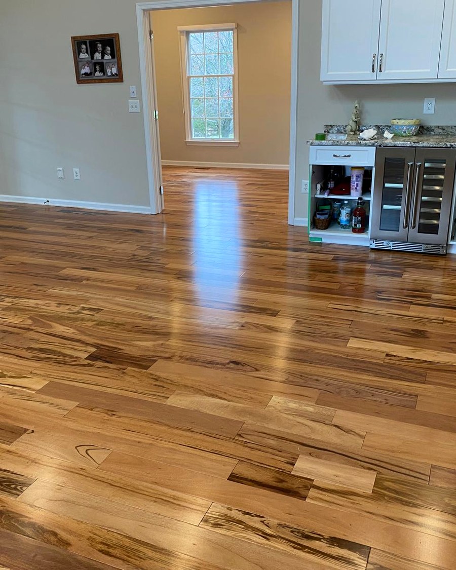 Exotic hardwood installed in an open living space with a custom wet bar.