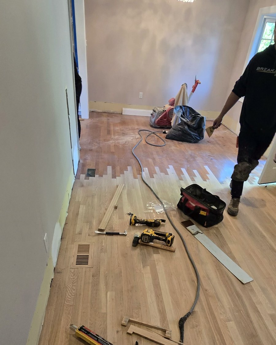 A damaged section of flooring repaired and patched in with a herringbone inlay.
