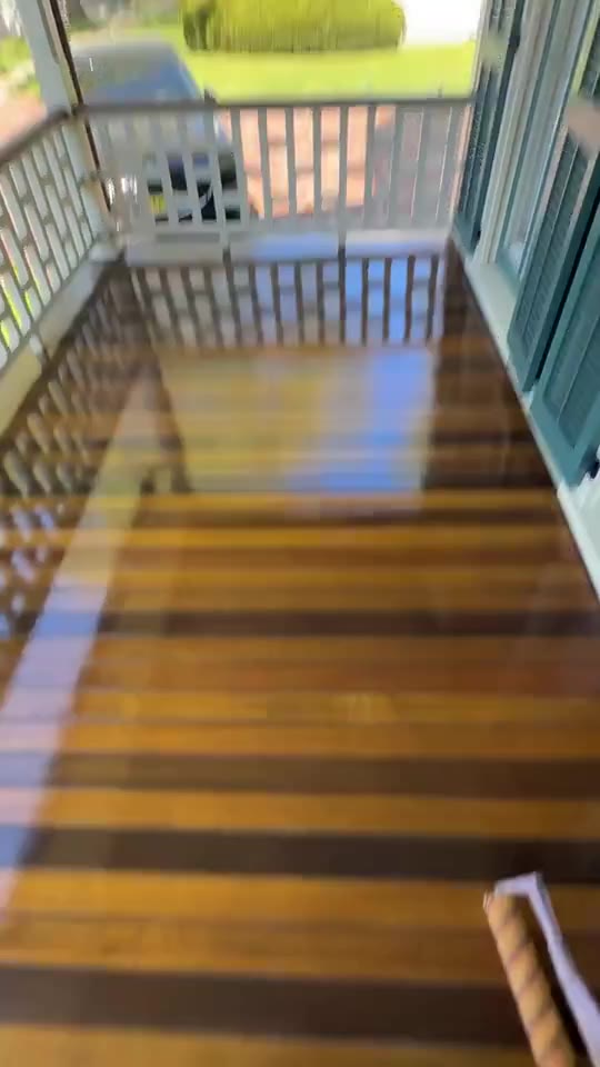 A freshly coated porch floor with a glossy, wet finish.