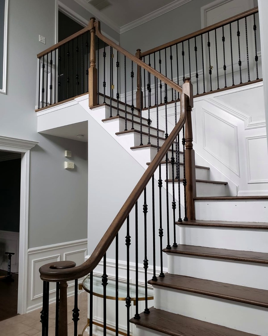 Stair treads and railing finished to match the surrounding hardwood floors.